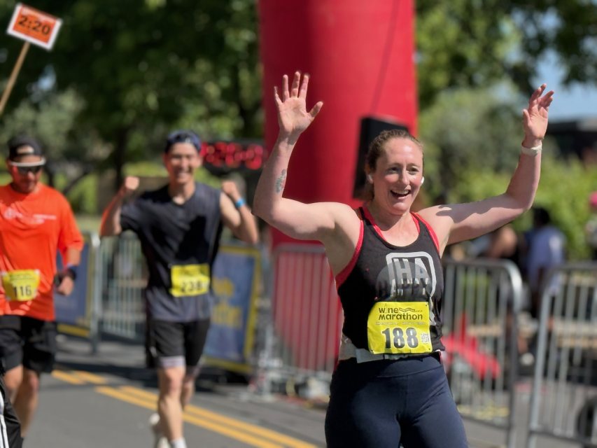 A runner celebrating at the finish