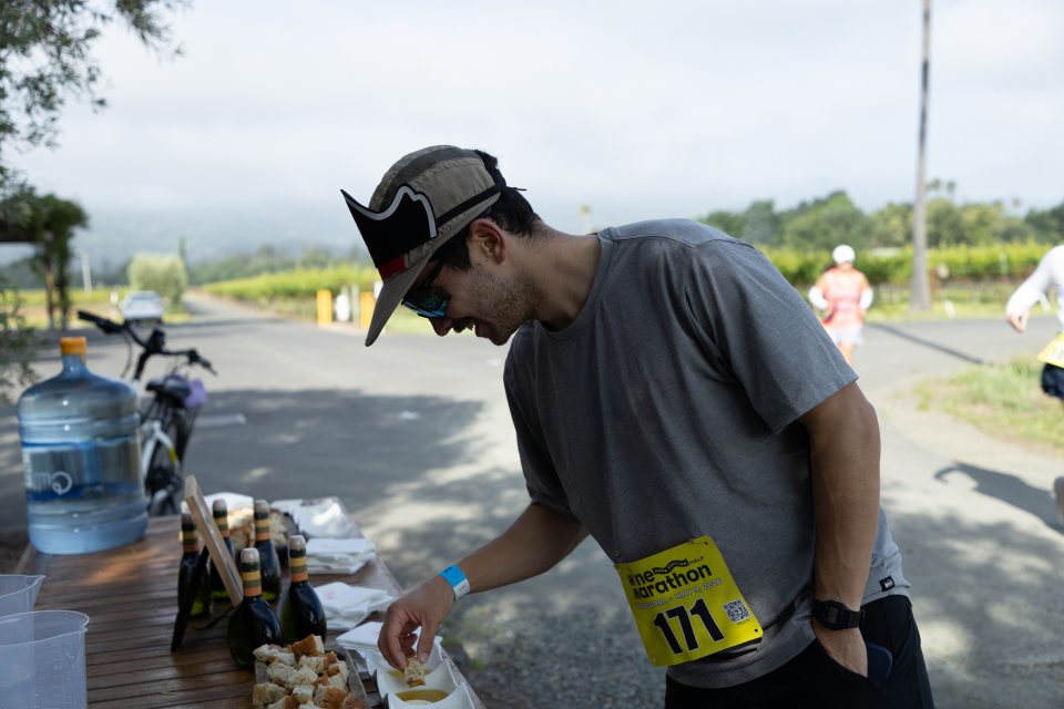 A runner tasting olive oil on the course